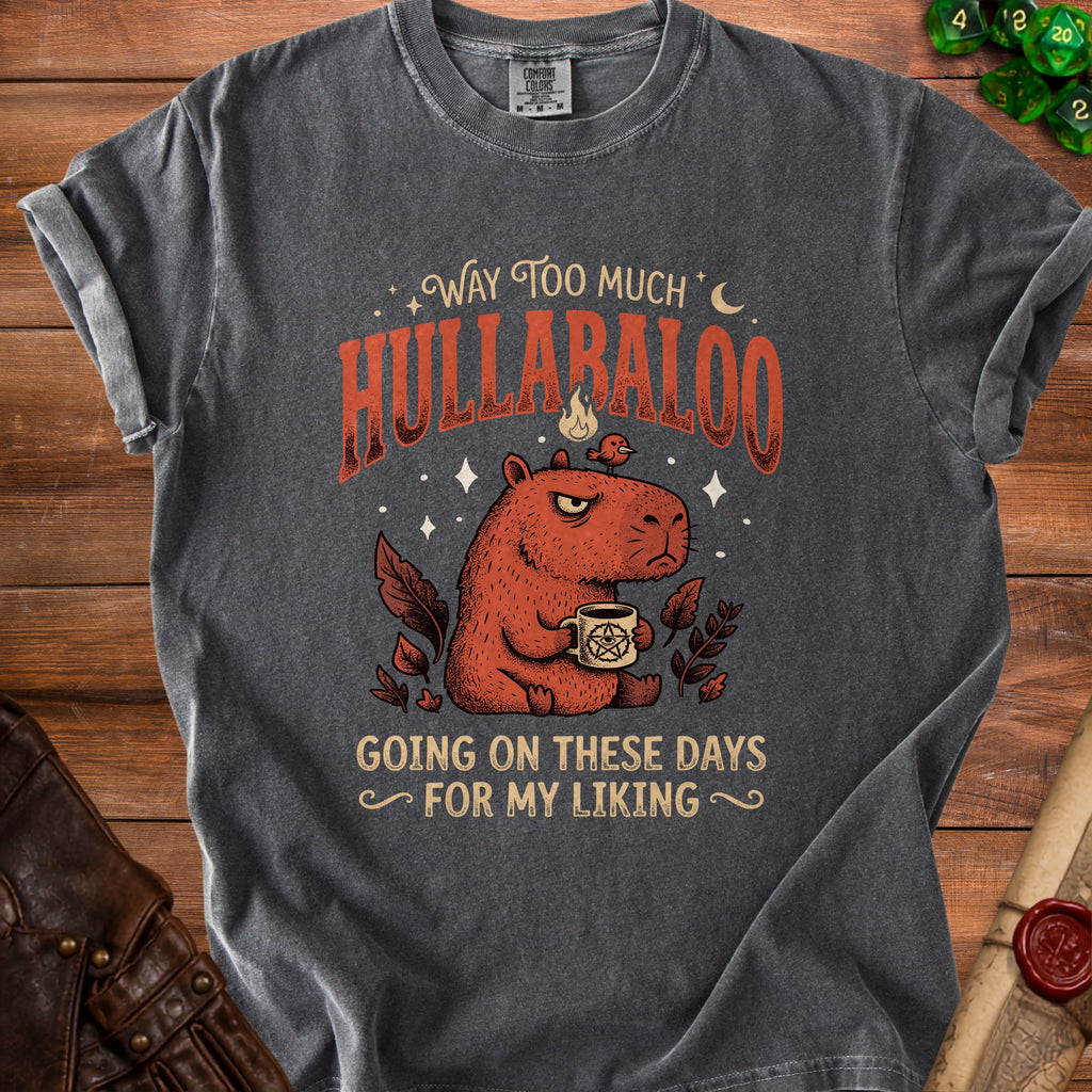 Charcoal t-shirt with a capybara, occult mug, and text: "Way Too Much Hullabaloo Going On These Days For My Liking."