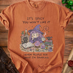T-shirt with witch graphic and text "It's spicy you won't like it" and "When people ask what I'm thinking."
