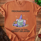 Orange t-shirt with "Procrastinator? I prefer the term Quest Delayer" and wizard graphic.