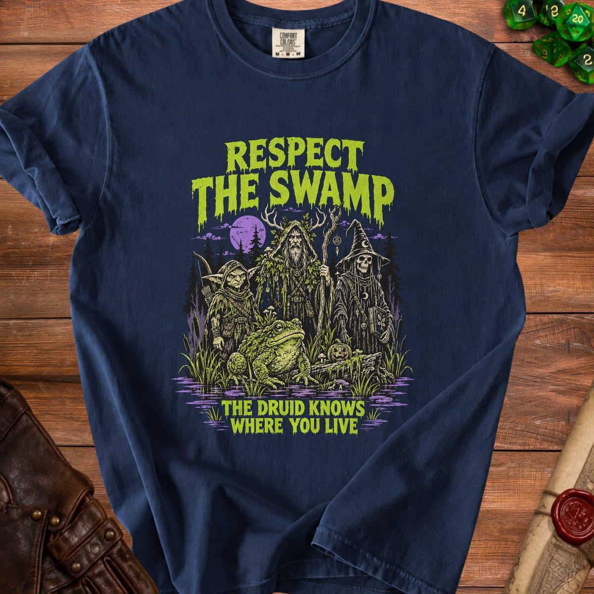 Dark blue t-shirt with "Respect The Swamp The Druid Knows Where You Live" text and swamp creatures.