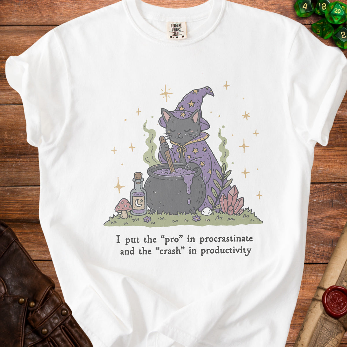 White t-shirt with a cartoon witch cat stirring a cauldron and text "I put the 'pro' in procrastinate and the 'crash' in productivity."
