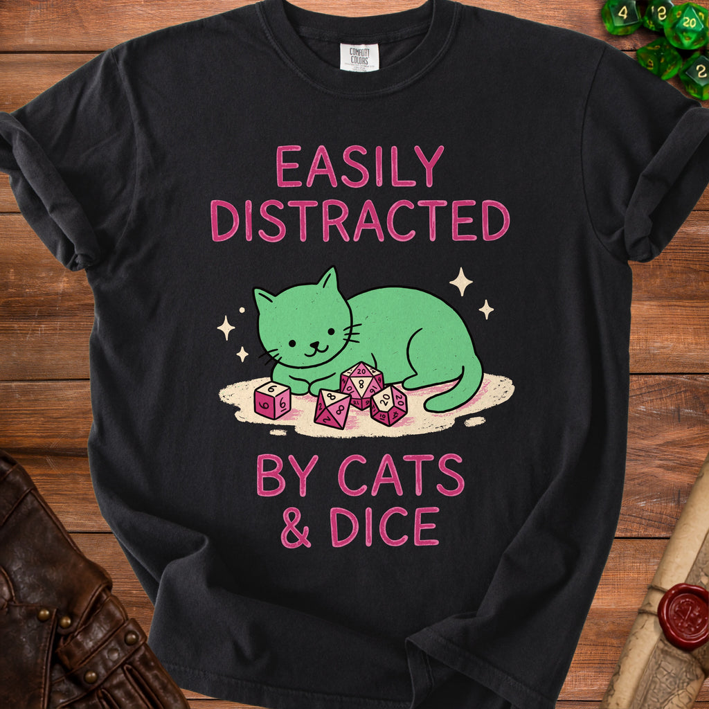 Black t-shirt with pink text "EASILY DISTRACTED BY CATS & DICE" and a green cat.