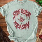 Light blue t-shirt with red "Side Quest Season" graphic and dice icons.