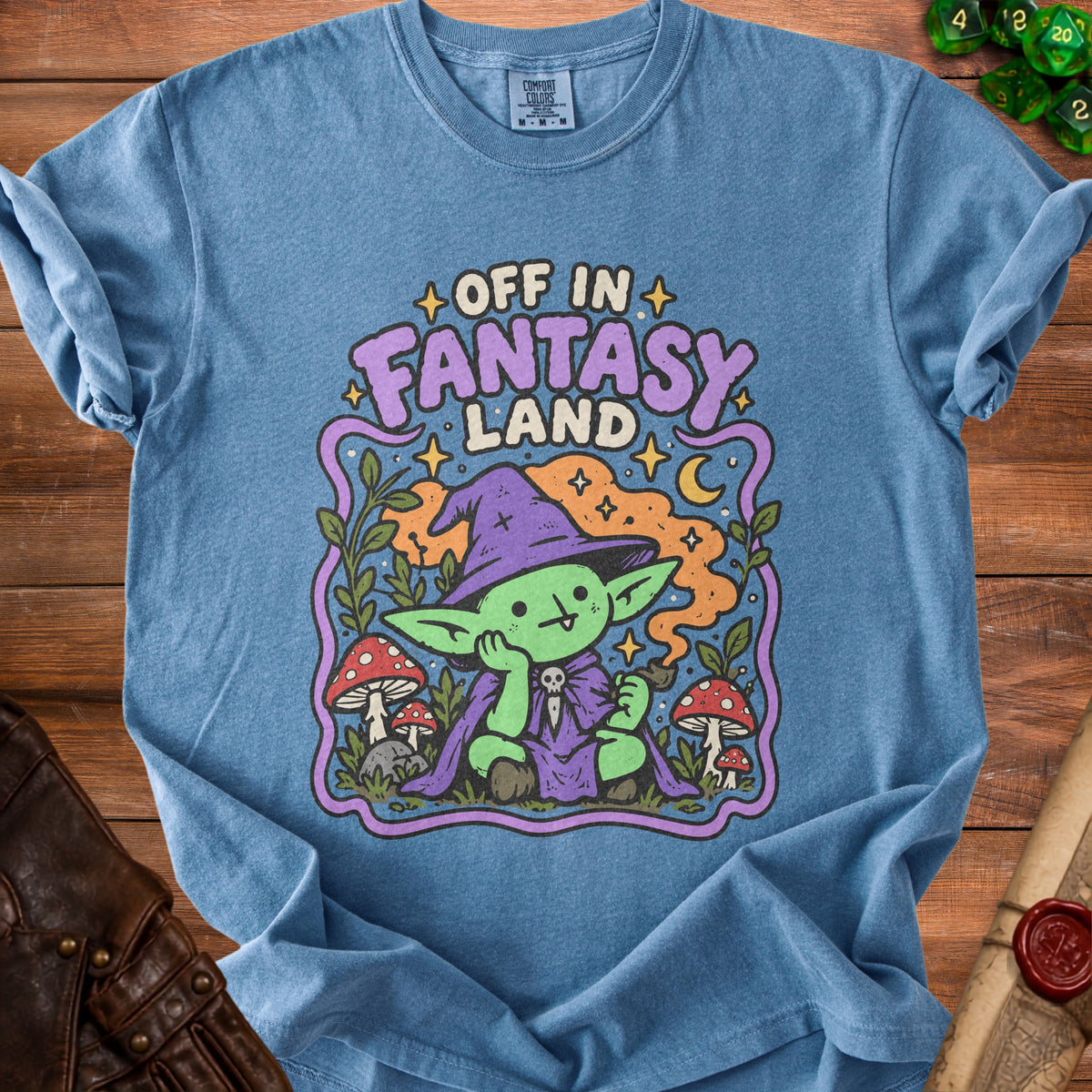 Blue t-shirt with "Off in Fantasy Land" text and a cartoon goblin character.