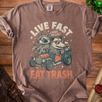 Raccoon and possum driving a car with "Live Fast Eat Trash" text.