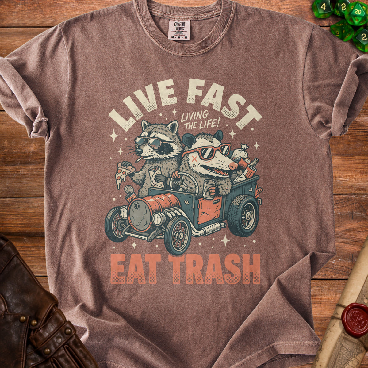 Raccoon and possum driving a car with "Live Fast Eat Trash" text.