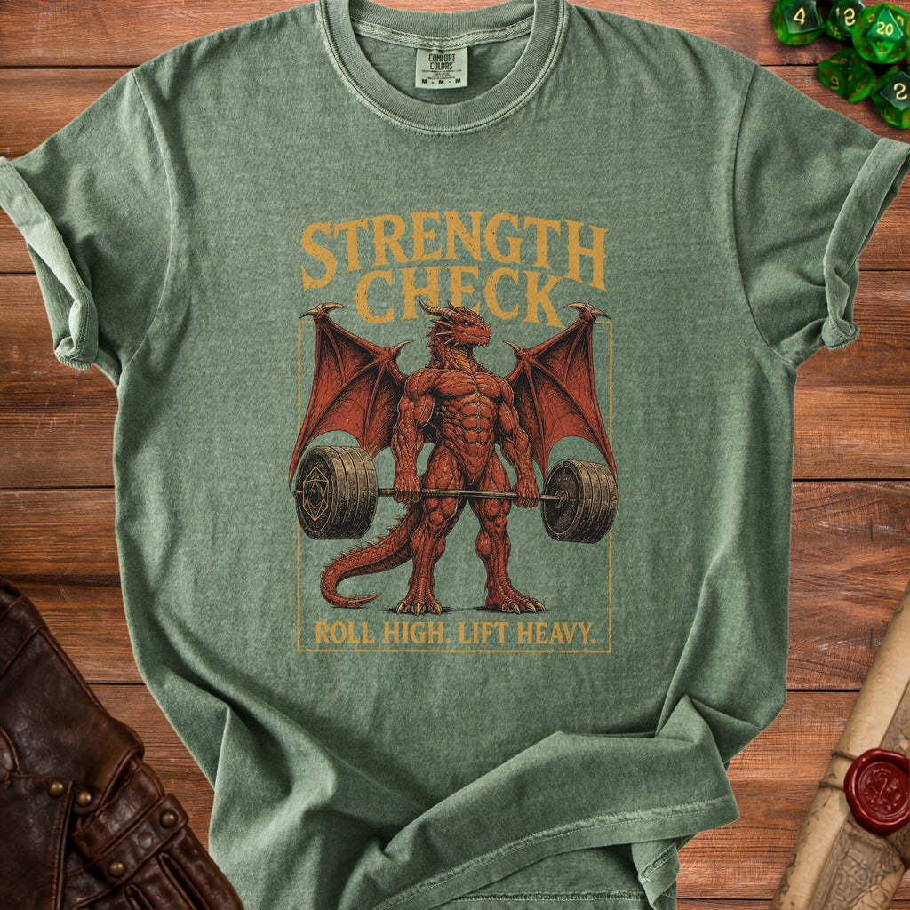 Green t-shirt with a red muscular dragon lifting weights, text reads "STRENGTH CHECK" and "ROLL HIGH. LIFT HEAVY.".