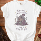 White t-shirt with illustration of a knight saying "Under this hard exterior lies a Silly lil guy".