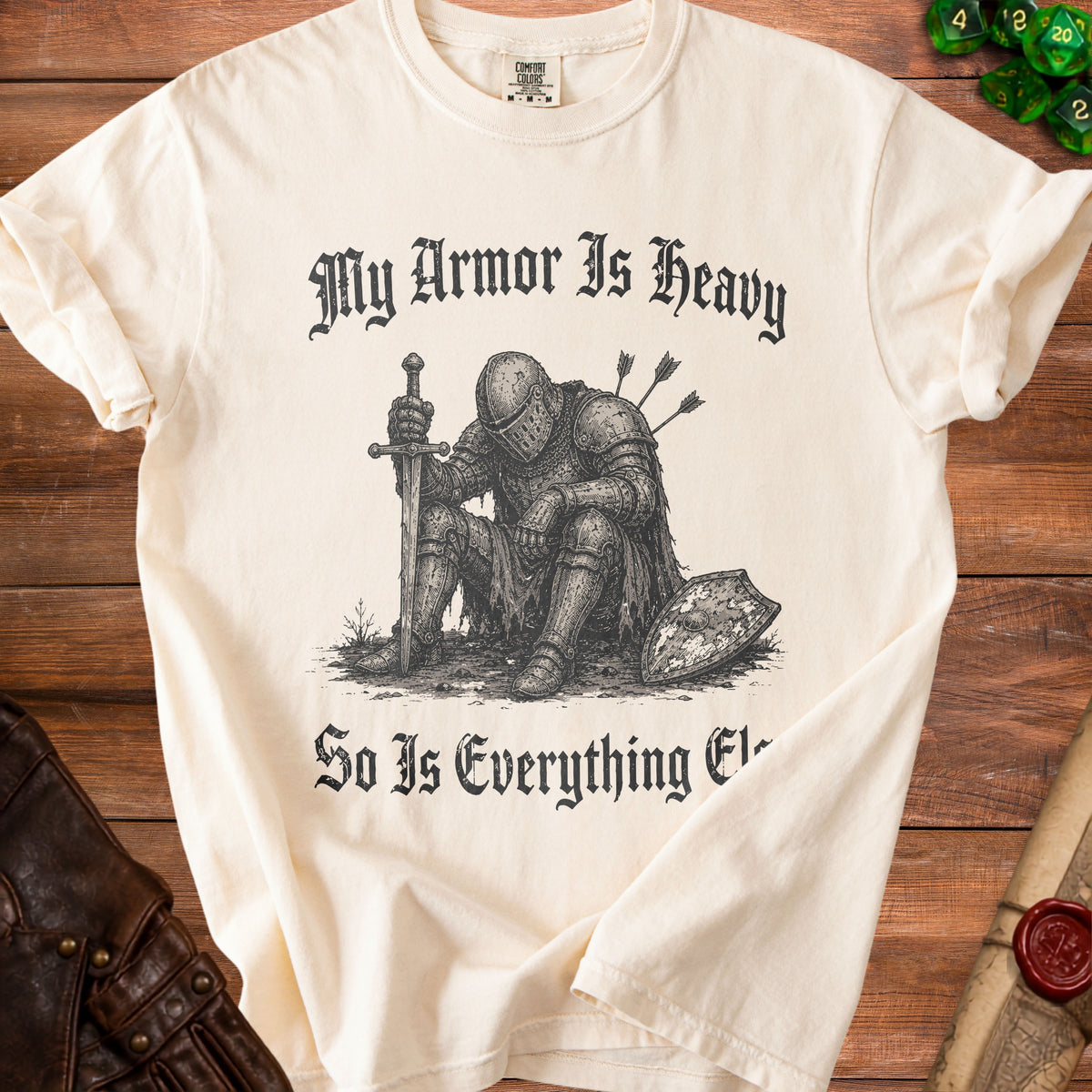Cream t-shirt with knight graphic and text "My Armor Is Heavy So Is Everything Else".