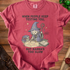 Shirt with a wizard drawing a pentagram and the text "When people keep testing you, but karma's too slow".