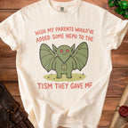 Cream t-shirt with a winged creature graphic and text "Wish My Parents Would've Added Some Nepo to the Tism They Gave Me".