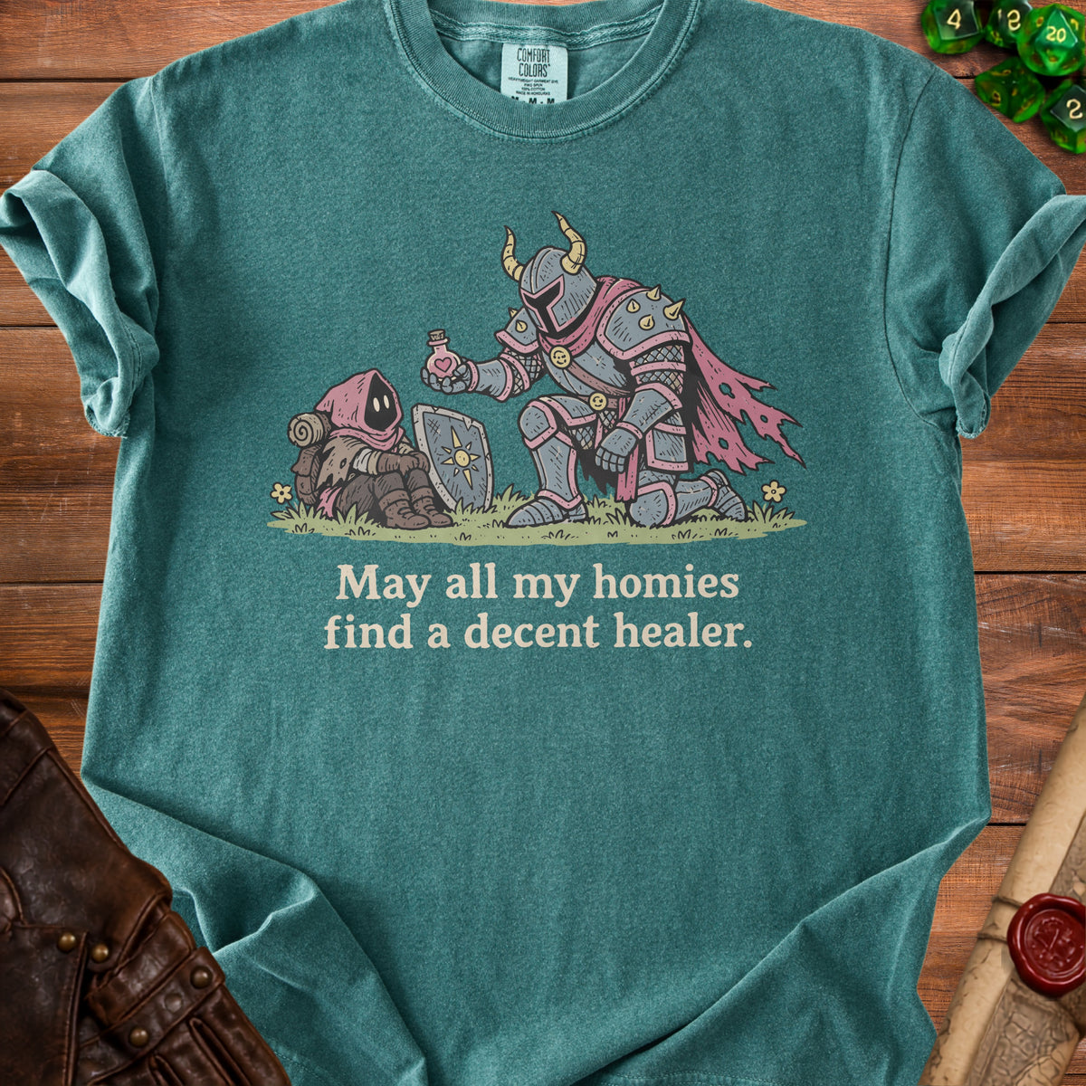 T-shirt graphic of knight offering potion to hooded figure with text "May all my homies find a decent healer."