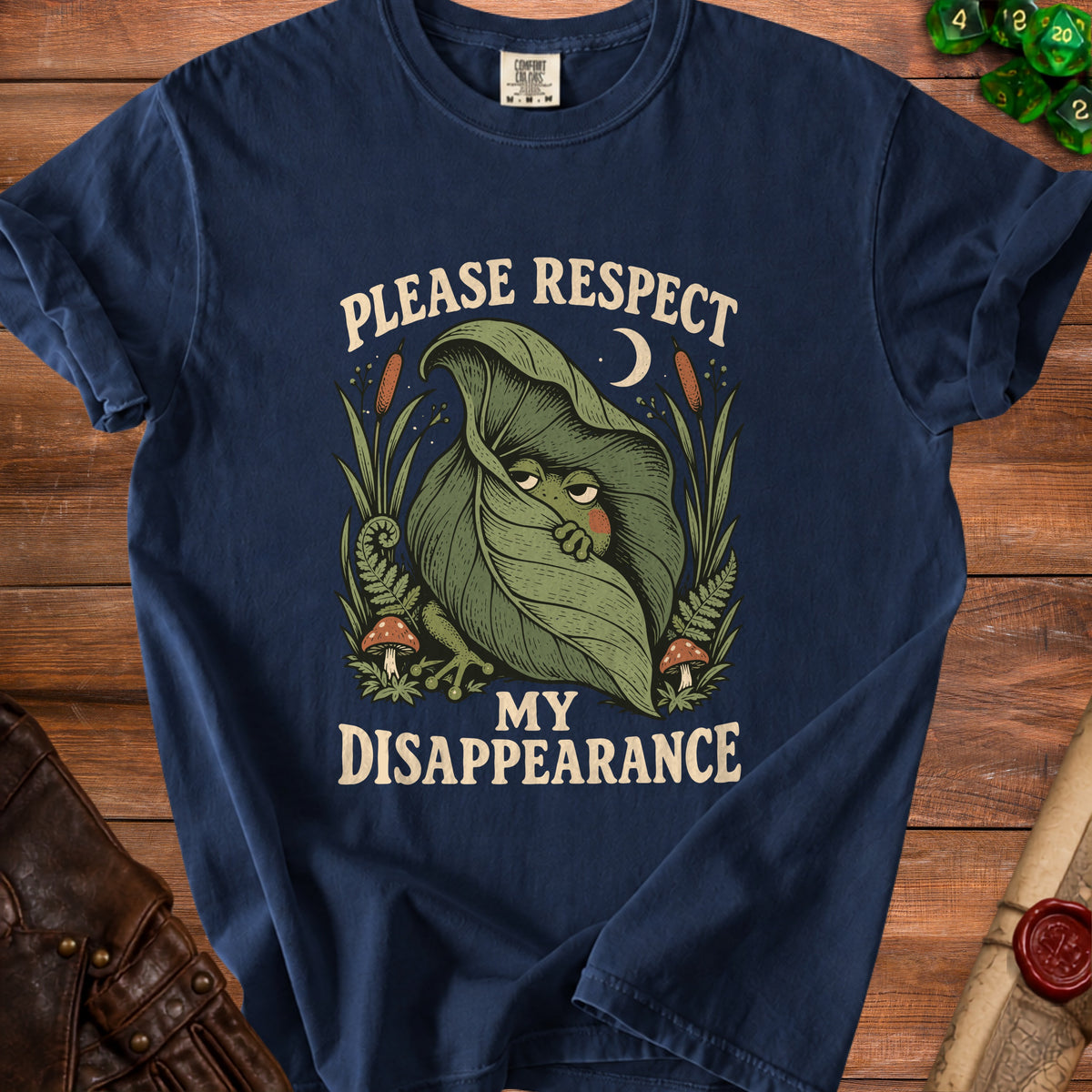 Navy t-shirt with a frog hiding under a leaf, reading "Please Respect My Disappearance".