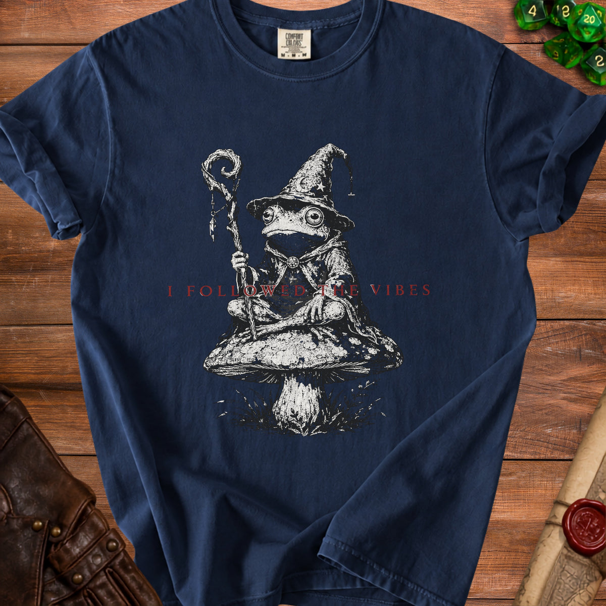 Dark blue t-shirt with wizard frog on mushroom and text "I FOLLOWED THE VIBES".