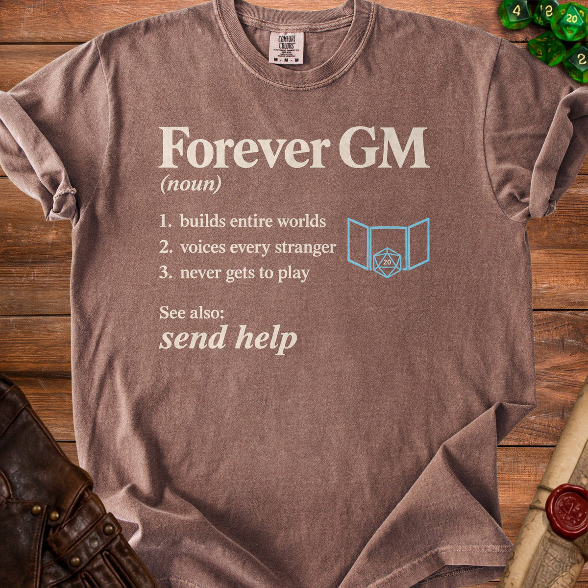 Brown t-shirt with "Forever GM (noun) 1. builds entire worlds 2. voices every stranger 3. never gets to play See also: send help" text.