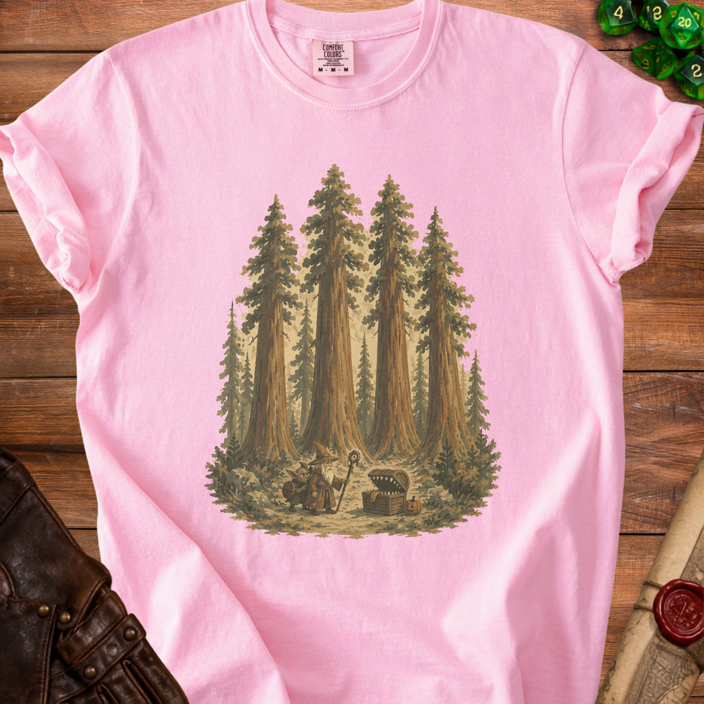 Pink t-shirt with a forest scene featuring a wizard, goblin, and treasure chest.