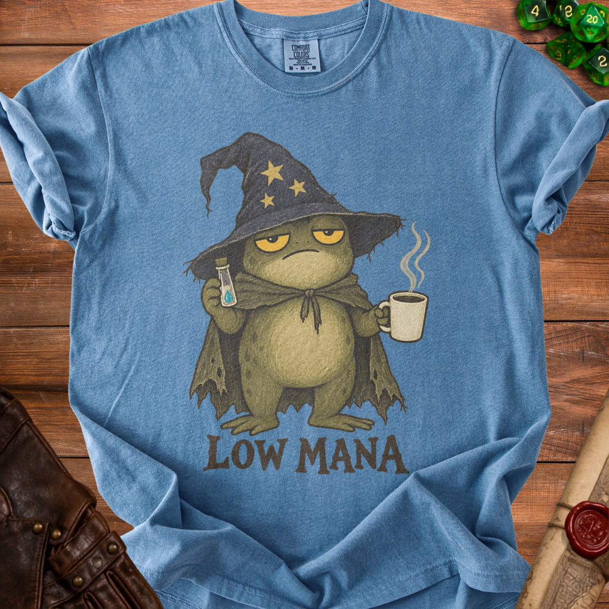 Blue t-shirt with graphic of tired frog wizard holding potion and coffee, text reads LOW MANA.
