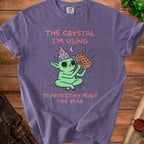 Green creature with wizard hat holding brick, text "The Crystal I'm Using to Protect My Peace This Year."