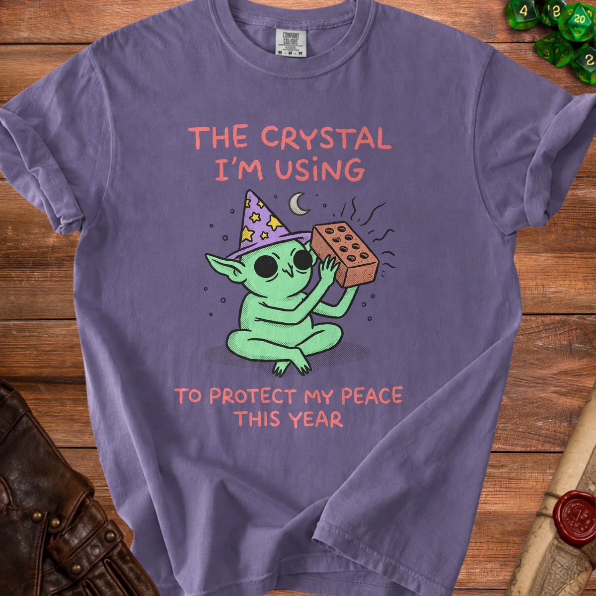 Green creature with wizard hat holding brick, text "The Crystal I'm Using to Protect My Peace This Year."
