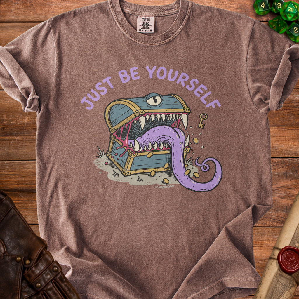 T-shirt graphic with a monster treasure chest and the text "JUST BE YOURSELF".