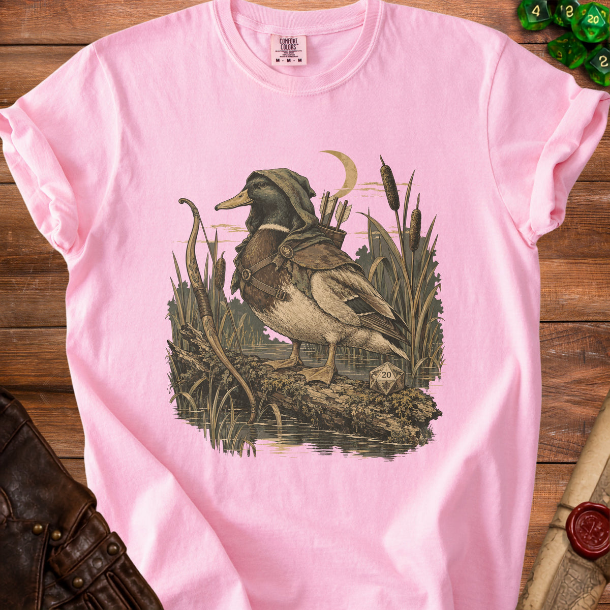 Pink t-shirt with a graphic of a hooded duck archer holding a bow and arrows.