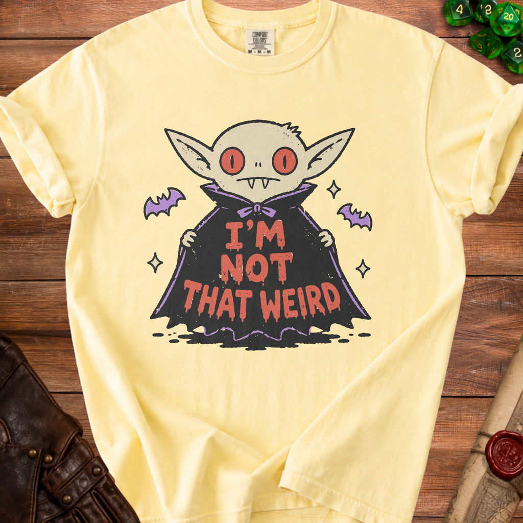 Yellow t-shirt with a cartoon vampire graphic reading "I'M NOT THAT WEIRD".