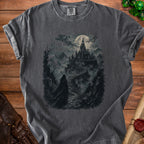 Dark t-shirt with a graphic of a cloaked figure approaching a haunted castle under a full moon.