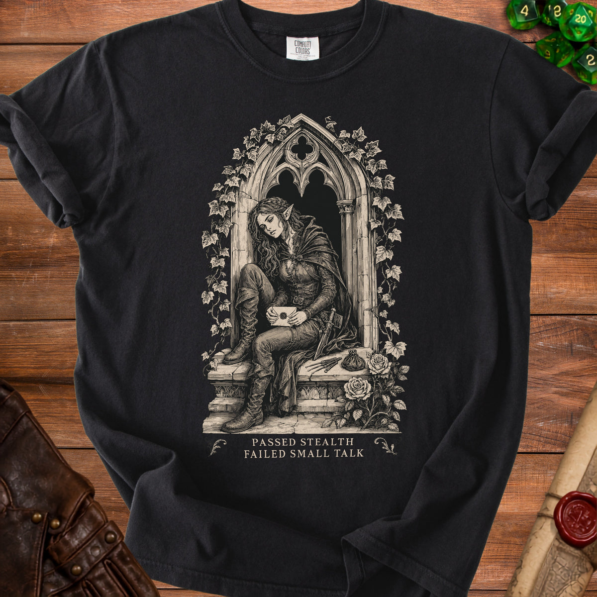 Black t-shirt featuring an elf in gothic architecture, text "PASSED STEALTH FAILED SMALL TALK".