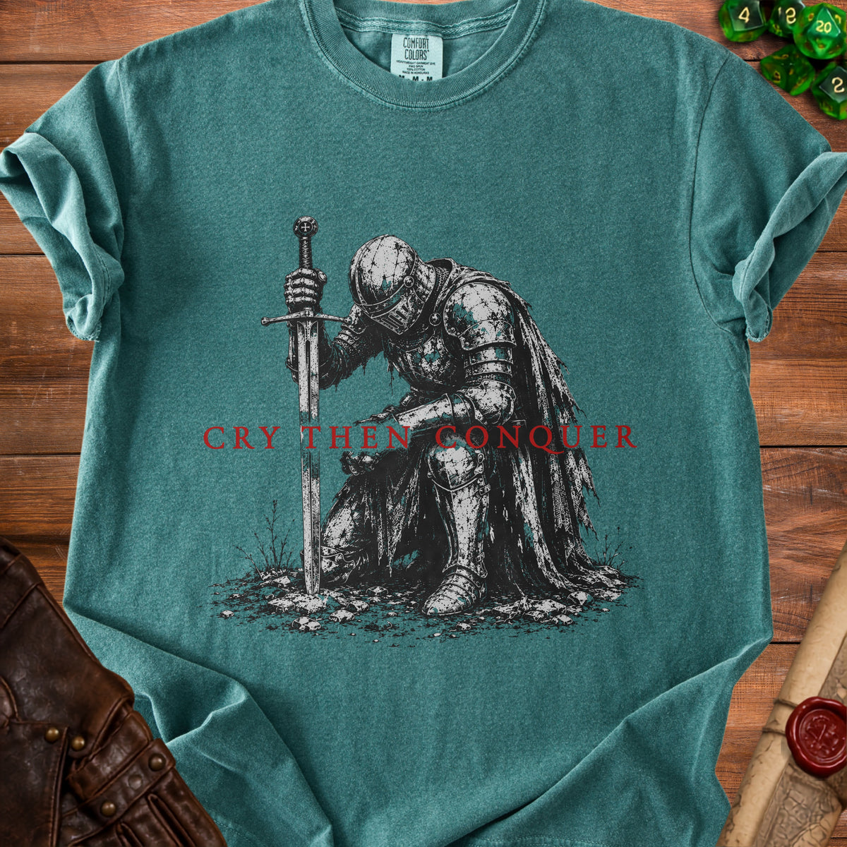 Green t-shirt with knight kneeling by sword, text "Cry Then Conquer."