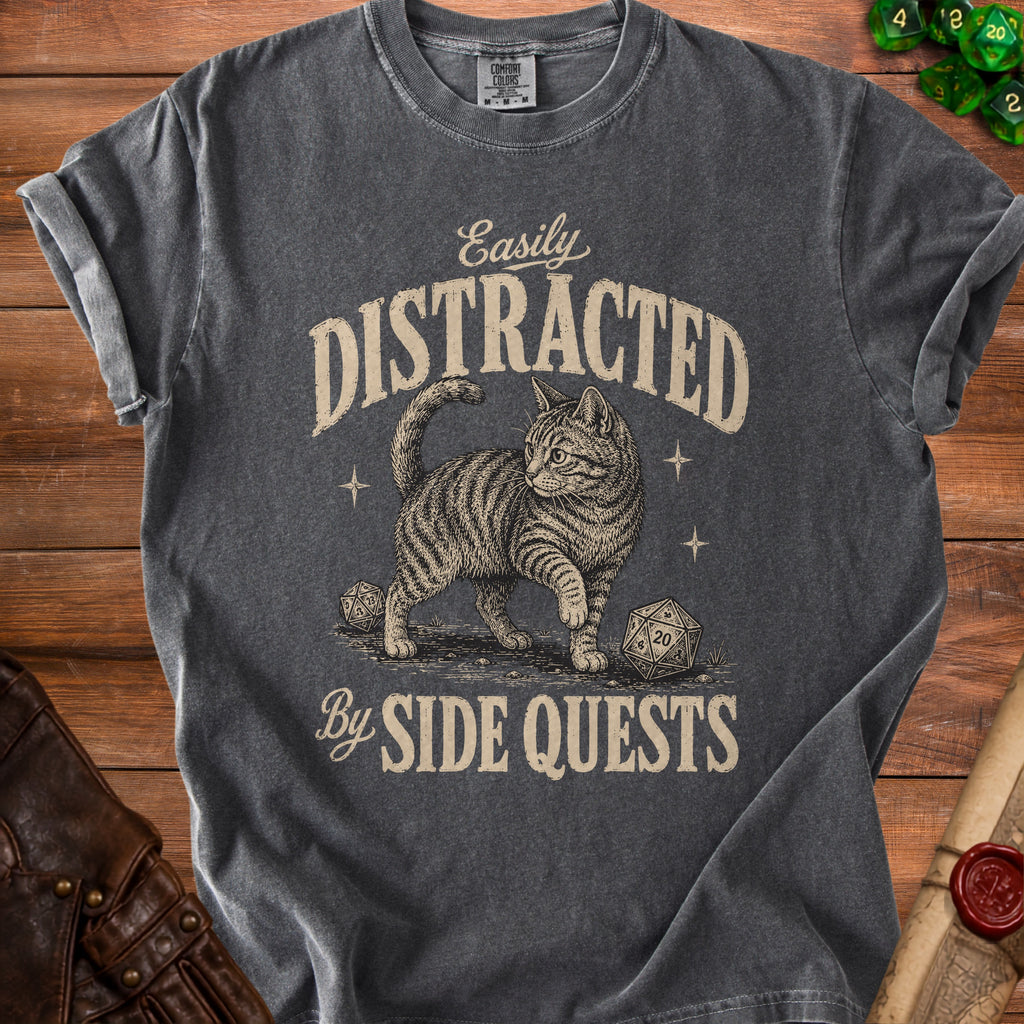 Dark grey t-shirt with a graphic of a cat and dice, reads "Easily Distracted By Side Quests".