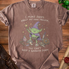 T-shirt with a cartoon goblin and the text "I MAKE JOKES ABOUT MY OWN TRAUMA, YOU CAN'T KEEP A GANGSTA DOWN".