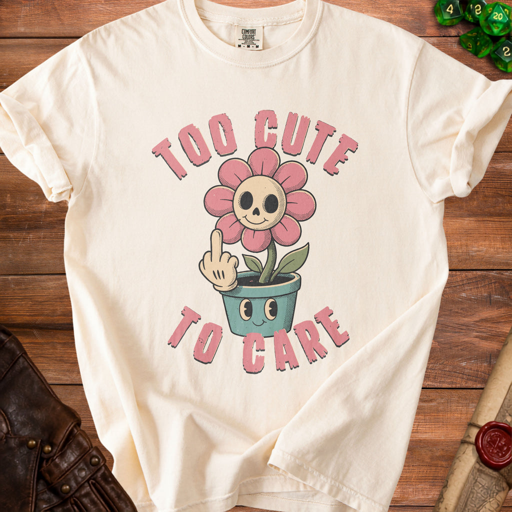 T-shirt with a graphic of a flower with a skull face and the text "TOO CUTE TO CARE".