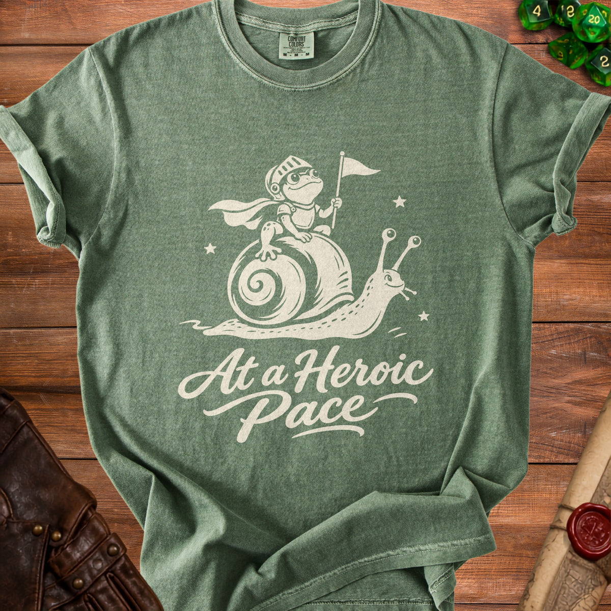 Green t-shirt with white graphic of a knight frog on a snail and text "At a Heroic Pace".