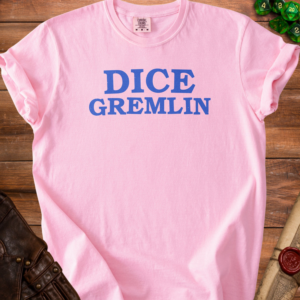 Pink t-shirt with blue "DICE GREMLIN" text, dice, and leather gloves.