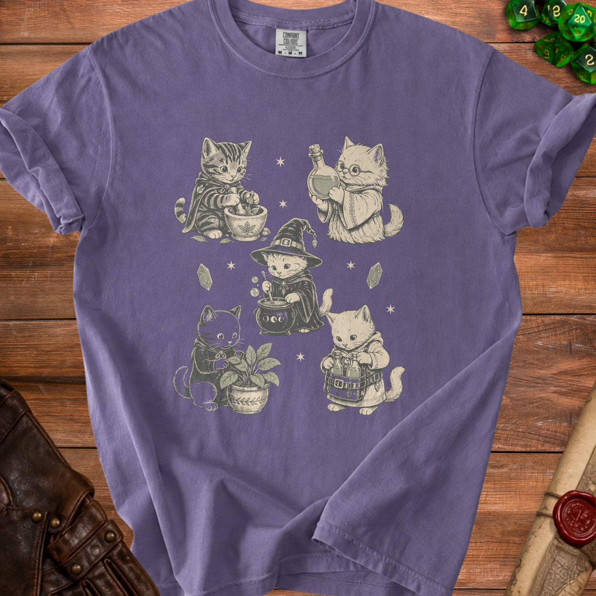 Purple t-shirt with a vintage-style print of five potion-making cats.