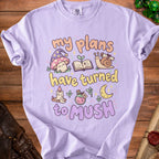 Light purple t-shirt with "my plans have turned to mush" text and whimsical illustrations.