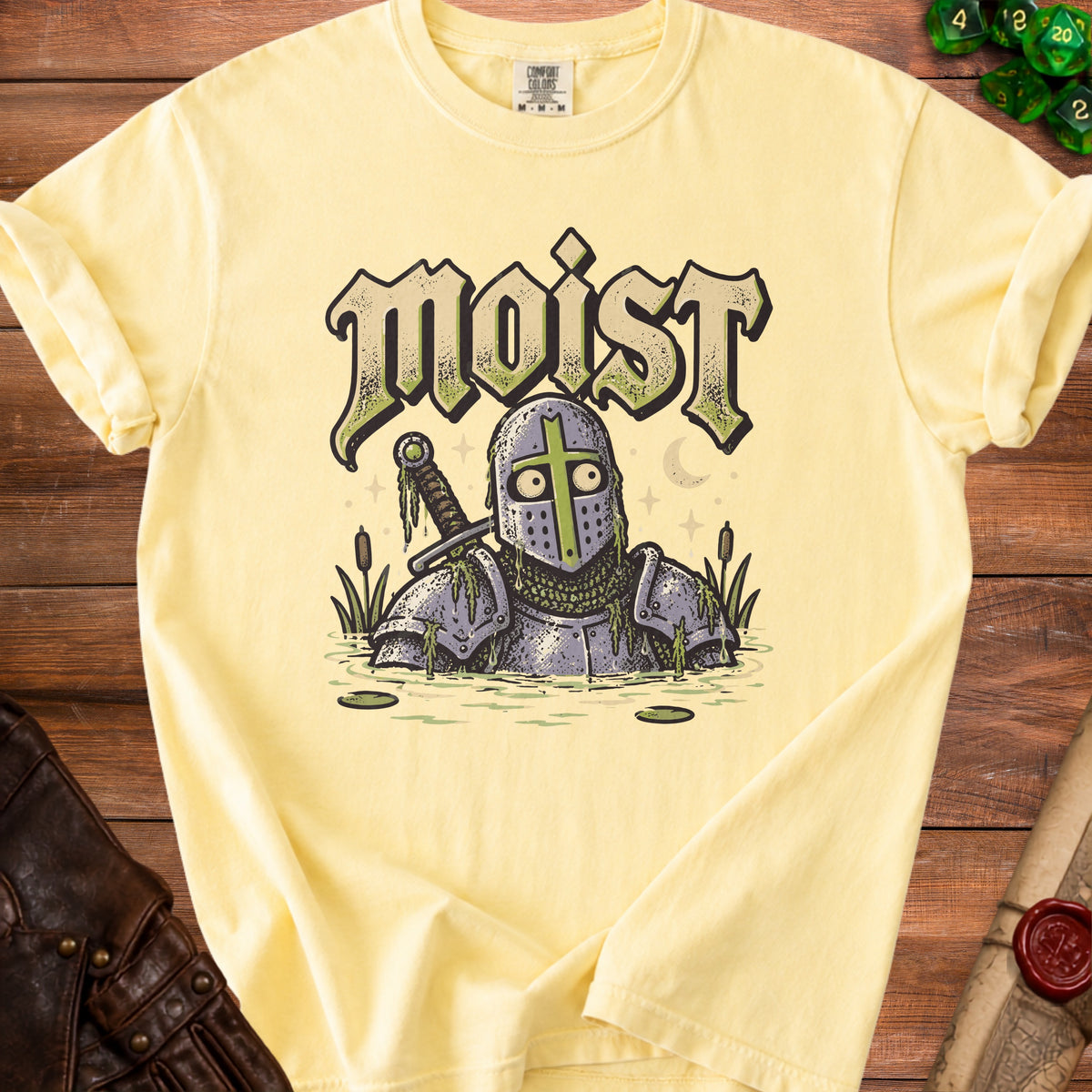 Yellow t-shirt with "moist" text and knight in swamp graphic.
