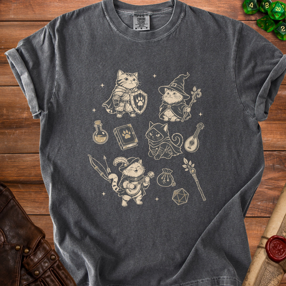 Dark gray t-shirt with beige fantasy cat adventurer graphic and dice.