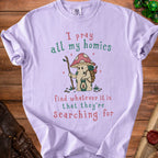 Light purple t-shirt with "I pray all my homies find whatever it is that they're searching for" and mushroom art.