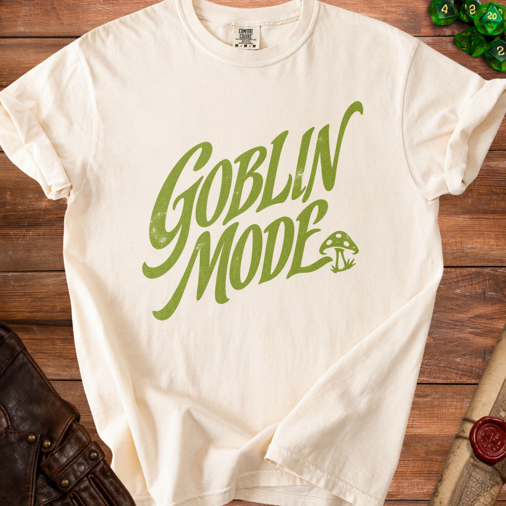 Cream t-shirt with green "Goblin Mode" text and a mushroom illustration.