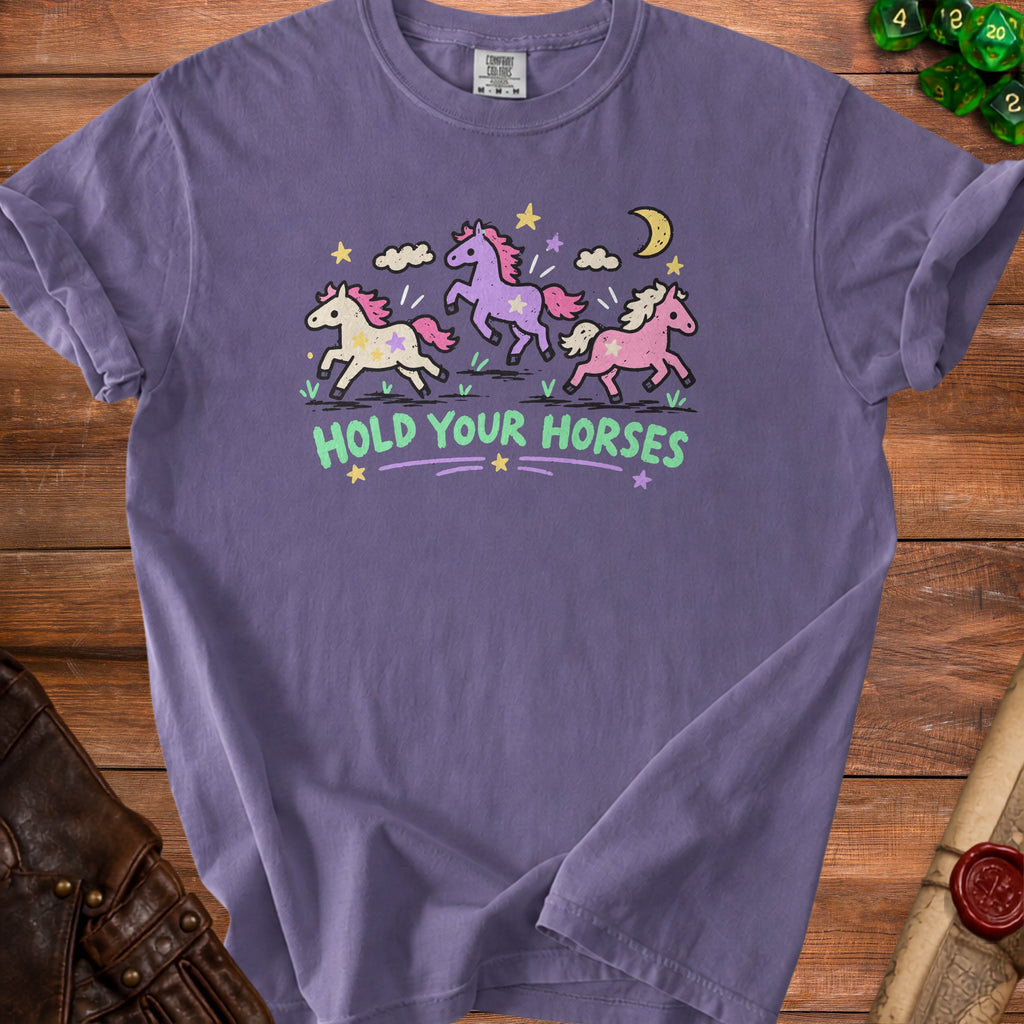 Purple t-shirt with graphic of three unicorns and text "HOLD YOUR HORSES."