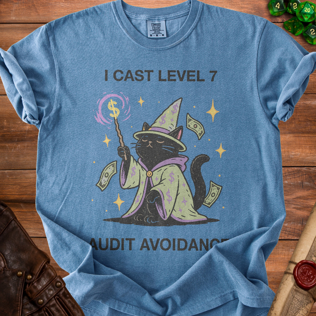 Blue t-shirt with black cat wizard graphic and text "I CAST LEVEL 7 AUDIT AVOIDANCE".