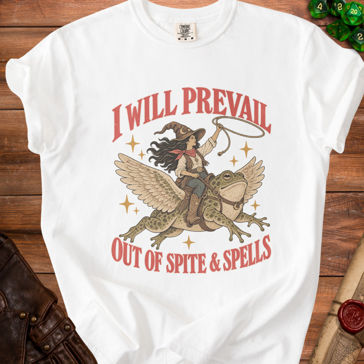 White t-shirt with graphic of witch riding winged frog, "I Will Prevail Out of Spite & Spells".