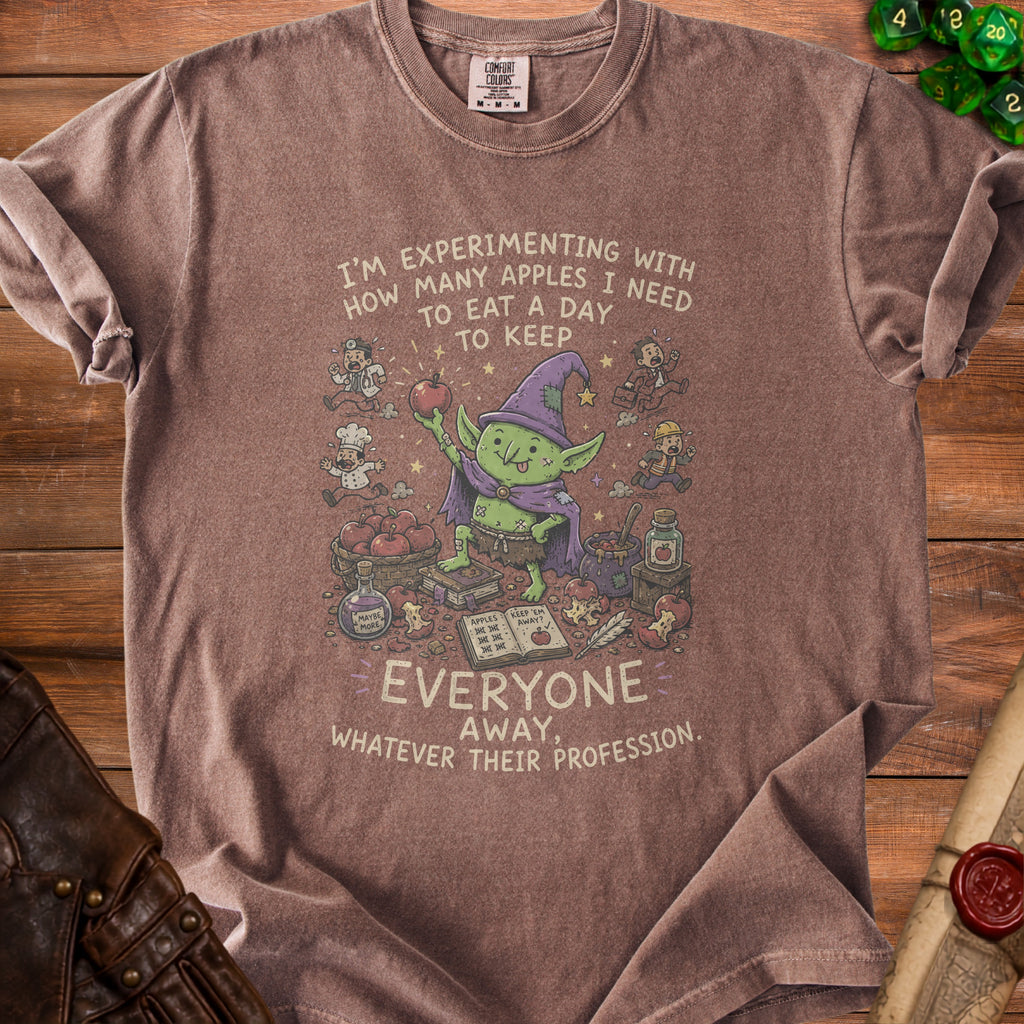 Brown t-shirt with a graphic of a goblin and text about apples.