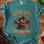 Teal t-shirt with "A Comfort in the Gloom Emotional Support Demon" graphic and a cute demon.