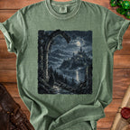Green t-shirt with a graphic of a robed figure approaching a moonlit castle.