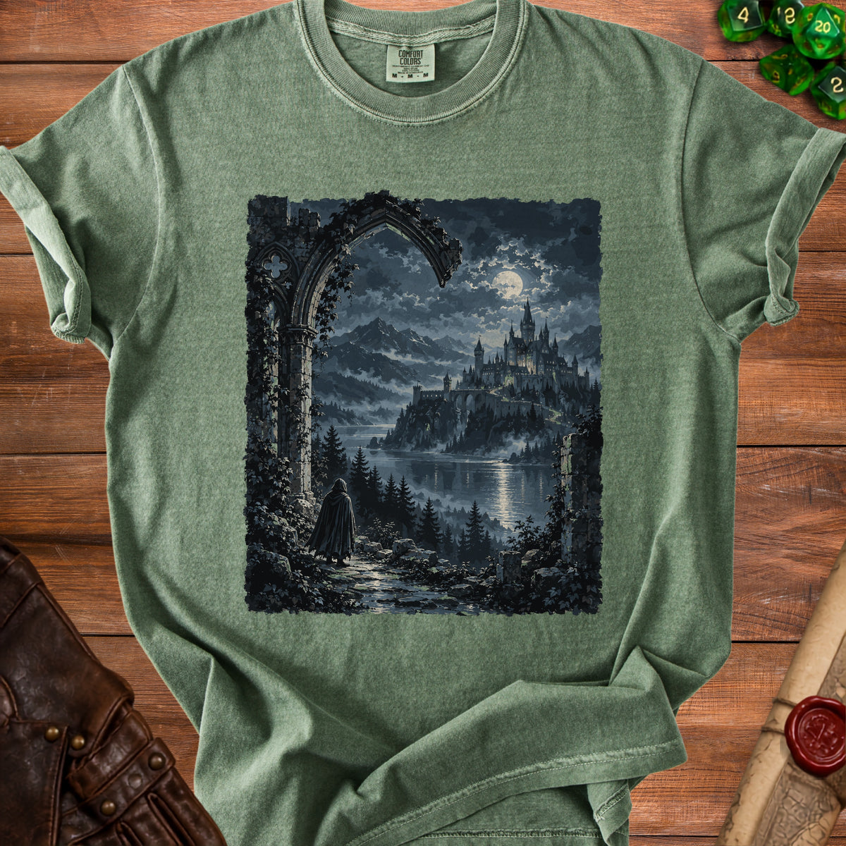 Green t-shirt with a graphic of a robed figure approaching a moonlit castle.