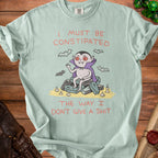 Light blue t-shirt with a cartoon vampire sitting on coffins and text.