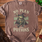 T-shirt with frog wizard illustration and "No Plan Just Potions" text.