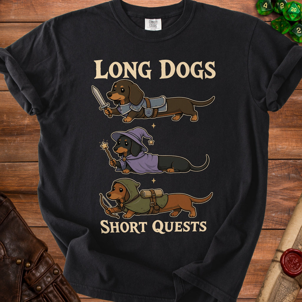 Black t-shirt featuring cartoon dachshunds in knight, wizard, and archer outfits with text "LONG DOGS SHORT QUESTS".